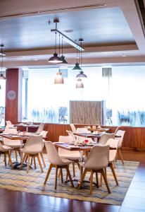 a row of tables and chairs in a restaurant at Southern Sun Rosebank in Johannesburg