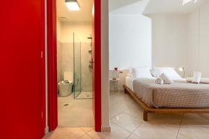 a bedroom with a bed and a glass shower at Mondrian Guest House in Skiathos