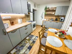 a kitchen and dining room with a table and chairs at Villa Felicity in Nová Lesná