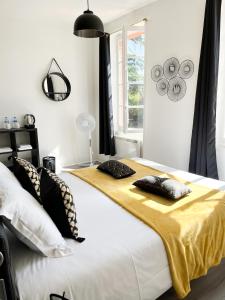 a bedroom with two beds with black and white pillows at Ch&acirc;teau Lamothe in Bazi&egrave;ge