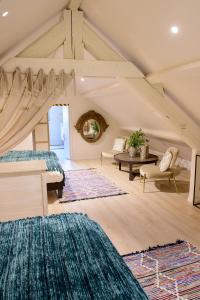 a room with two beds and a table and chairs at Le Clos des Ecureuils in Saint-Héand