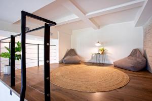 a room with a round rug on the floor with two pillows at Genteel Home Almirante Lobo in Seville