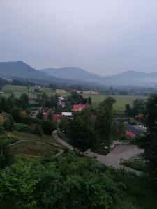 a view of a town with mountains in the distance at Penzion PALMA in Frýdlant nad Ostravicí