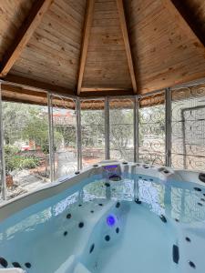 a hot tub in a room with windows at Ch&acirc;teau Lamothe in Bazi&egrave;ge
