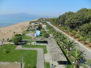 an aerial view of a beach with palm trees and a road at Phivos Home & Garden in Messini