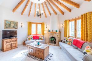 a living room with a couch and a tv at Villa Rafael in Cumbre del Sol