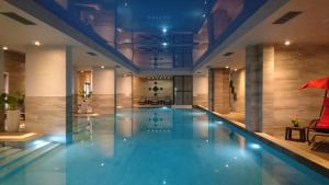 a large swimming pool in a building at Burgas Residence 809 in Burgas City