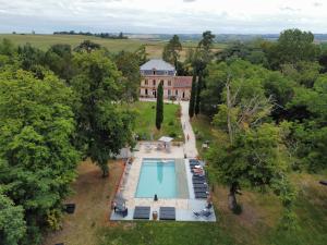 an aerial view of a mansion with a swimming pool at Château Lamothe in Baziège