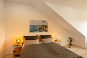 a bedroom with a bed and two night stands at SweetHome - Poing Apartments in Poing