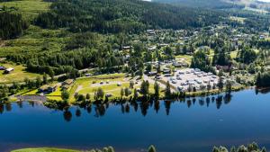 an aerial view of a resort on a lake at Trysilelva Camping & hytter in Trysil