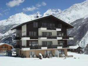 a large building on top of a snow covered mountain at Appartment Alpenrose in Saas-Fee