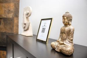 a statue of a buddha sitting on a table at Second line Puerto Banús top floor in Marbella
