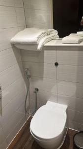 a bathroom with a white toilet and a sink at Perfect Stay Dubai in Dubai