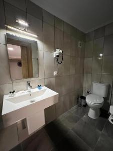 a bathroom with a sink and a toilet at Bayram Hotel in Cesme