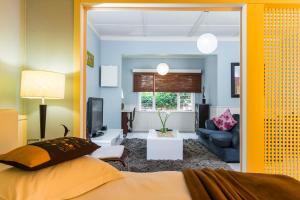 a bedroom with a bed and a living room at Villa Margherita in Swakopmund