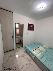 a bedroom with a bed in a room with a mirror at Locuință privată la mare in Schitul