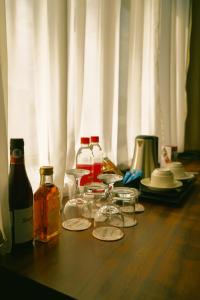 a wooden table with bottles and glasses on top of it at City Hotel Bishkek in Bishkek