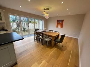 a kitchen and dining room with a table and chairs at Modern and cosy 4 bedroom home in the Mendip Hills, North Somerset in Axbridge