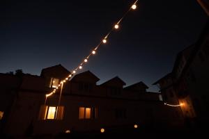 a string of lights hanging over a building at night at Confort Plus in Sibiu