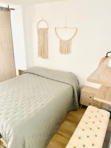 a bedroom with a bed and a table and a lamp at Pontevedra Apartments -New Loft Centro Pontevedra in Pontevedra