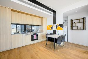 a kitchen and dining room with a table and chairs at Stunning New 2 Bedrooms Apt Shopping & Parking in Sydney
