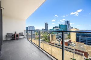 a balcony with a view of a city skyline at Stunning New 2 Bedrooms Apt Shopping & Parking in Sydney