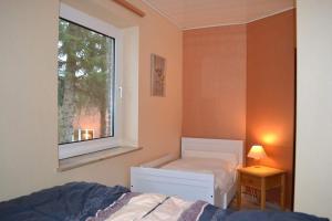 a bedroom with a bed and a window at Utlande-18 in Brösum