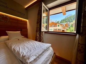 En eller flere senge i et værelse på Cesa Planber Apartments Mountain View SKI-IN SKI-OUT