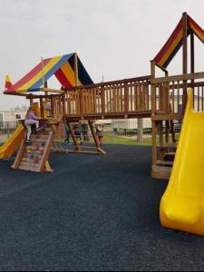 a park with a playground with a slide and a slideintend at Captivating 3-Bed Caravan at Golden Palm Skegness in Skegness