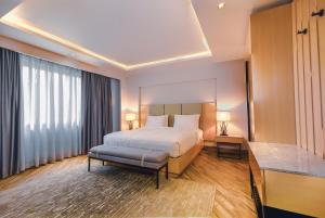 a hotel room with a bed and a desk at The Row Residential Hotel in Addis Ababa +39 photos