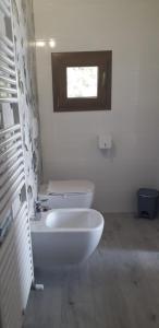 a bathroom with two white sinks and a window at Agriturismo Cascina Lert in Marone