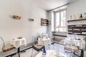 a restaurant with two tables and chairs in a room at Hotel Max in Rome