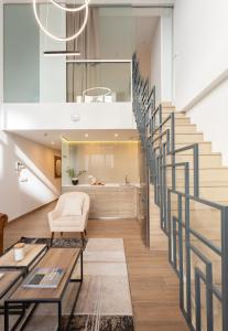 a staircase in a living room with a couch and a table at General Oráa - Darya Living in Madrid