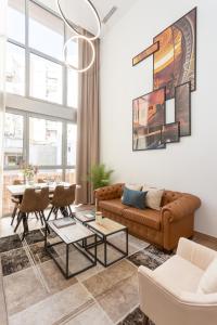 a living room with a couch and a table at General Oráa - Darya Living in Madrid