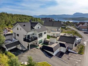 an aerial view of a large white house at Aurora apartment in Kvaloya Tromso in Tromsø