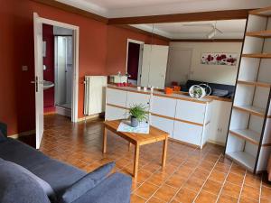 a living room with a couch and a table at B&B Des Bois Sans Nombre in Paliseul