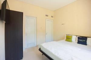 Letto o letti in una camera di Urbanview Resort Adang Zecky Cisarua Puncak by RedDoorz