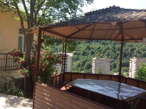 a hot tub on the balcony of a house at Комната с видом на горы in Dilijan