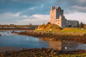 a castle on an island with a body of water at Eia Street Apartments Belfast in Belfast