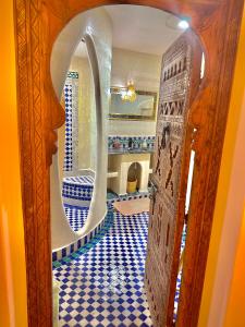 a hallway with a blue and white tile floor in a room at Dar Ahlam Dades in Aït Ouaddar