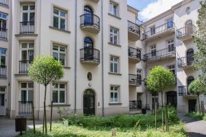 an apartment building with balconies and trees at GROBLE 19 in Kraków