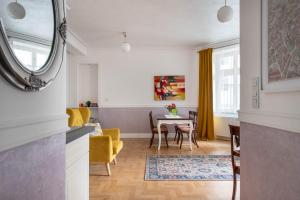 a kitchen and living room with a table and chairs at GROBLE 19 in Kraków +18 photos