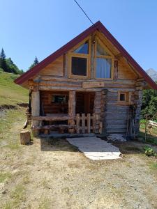 a log cabin with a porch and a window at Komovi - Montenegrina Mountain house in Kolašin