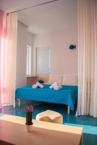 a bedroom with a bed with a blue bedspread at Villa Mina in Ohrid