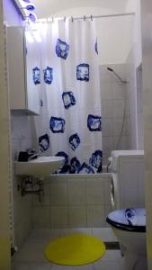 a bathroom with a sink and a blue and white shower curtain at ZAGREB Botanical Garden Budget Apartment in Zagreb