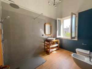 a bathroom with two sinks and a mirror at Domus Trinchese Dimora Storica in Martano +22 photos