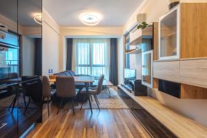 a kitchen and dining room with a table and chairs at Burgas Residence 809 in Burgas City