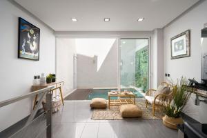 a living room with a view of a pool at Downtown Pool House in Faro