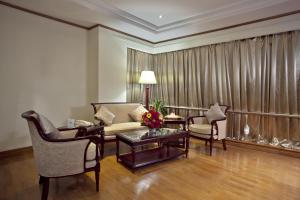a living room filled with furniture and a table at The Peninsula Chittagong Limited in Chittagong