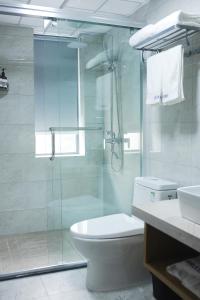 een badkamer met een douche, een toilet en een wastafel bij Chongqing Jianfeng Hotel in Fuling